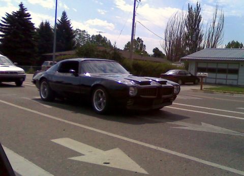 2006 Ford E350 - This black classic muscle car appears to be a 1970s Pontiac Firebird Trans Am.