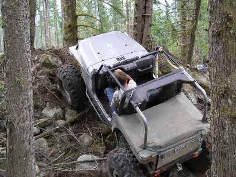 1979 Ford Bronco - This vehicle is navigating a challenging off-road trail, with a second vehicle visible in the distance.