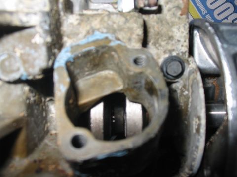 1992 Ford Bronco - This is a close-up view of an engine part, possibly a water pump housing, showing some wear and sealant.