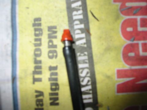 1992 Ford Bronco - Close-up of a fuel injector with an orange protective cap.