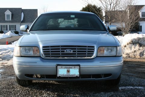 1999 Ford Crown Victoria - Front view of a light blue 1999 Ford Crown Victoria parked outdoors in winter.