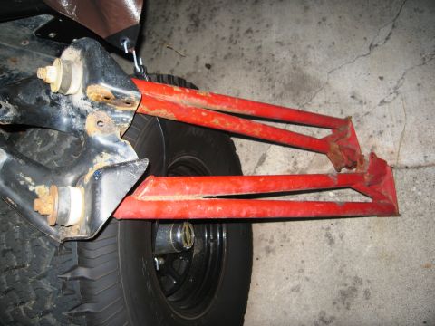 1986 Ford Bronco - Close-up view of red radius arms and suspension components.