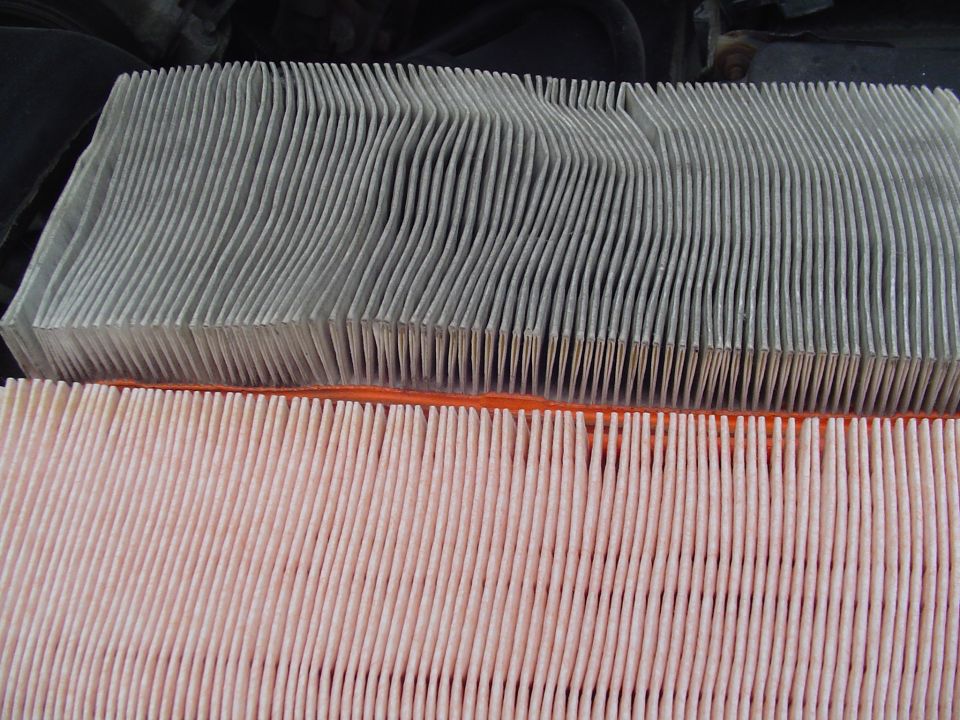 Used dirty air filter compared with a clean new air filter