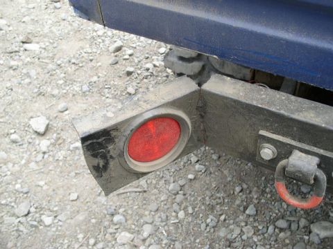 1979 Ford Bronco - Close-up of a vehicle's rear bumper, showing a taillight and tow hook.