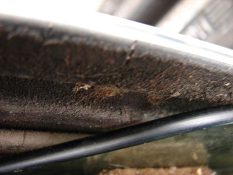 1973 Ford Ranchero - Detail of accumulated dust and debris on aged interior trim, showing signs of wear.