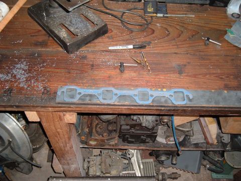 1981 Ford LTD - Fel-Pro 1415 exhaust gasket on top of the stock. I'll be cutting the ports to match the gasket but drilling the wider World Products 3" bol…