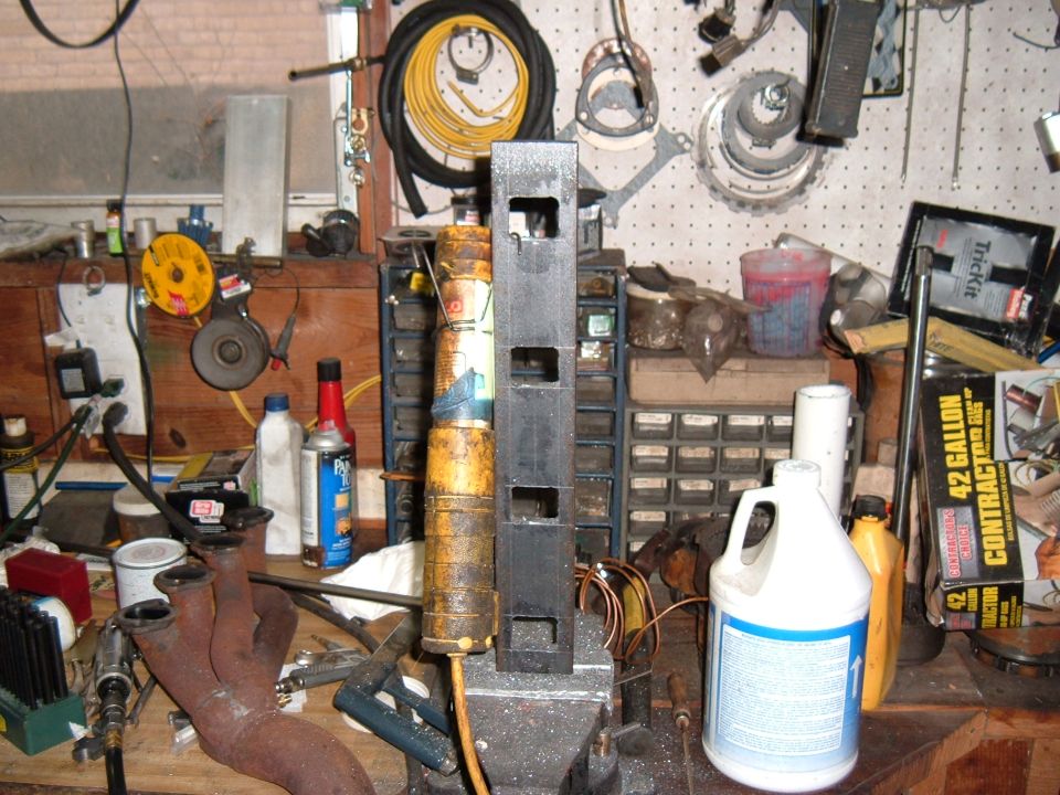 Once all the holes were roughed out I ground the sides smooth, straight, and square with a tungsten carbide burr in my die grinder. I use a short burr to get the ports close and a 6" long burr to finish them. The extra length lets me see what I'm doing and makes it easier to know that I'm square to the surface. I wear gloves for this because the carbide throws a lot of small razor sharp steel slivers. Even with the gloves I spent awhile with tweezers picking them out of my hands. Otherwise they rust in place and you get what I call carbide freckles.
