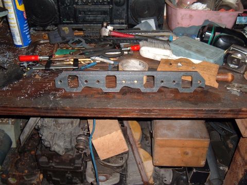 1981 Ford LTD - Finished flange with all the bolt holes drilled, spark plug boots and header bolts cleared, and ports done. Total cost in materials, $10. T…