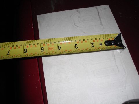 1991 Ford Bronco - A yellow tape measure is placed over a white sticker with embossed block lettering.