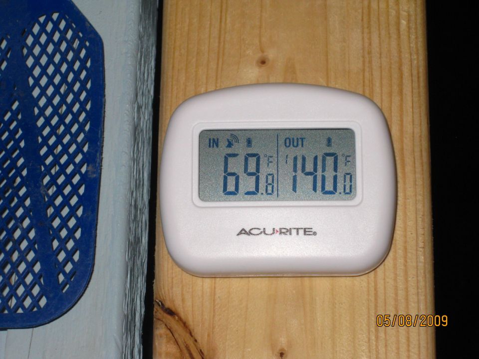 Acurite digital thermometer displays 69.8F indoors and 140.0F outdoors. Date stamp reads 05/08/2009