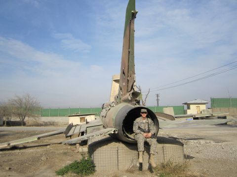2003 Jeep Wrangler - A soldier poses inside the debris of a military aircraft in an outdoor, arid environment.