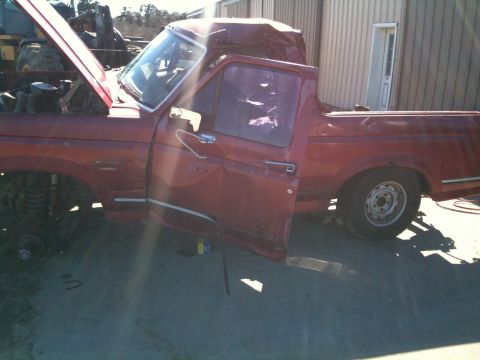 1993 Ford Bronco - This 1993 Ford Bronco shows significant damage to its roof and appears to be in a state of disrepair.