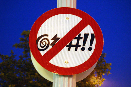 sign with symbols like a swirl, lightning bolt, hash, and exclamation points, all crossed out