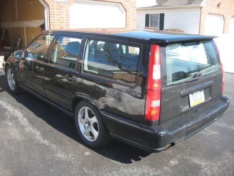 1993 Ford Probe - This black Volvo 850 wagon is seen from the rear 3/4 angle. The license plate is visible and reads FSU 108.