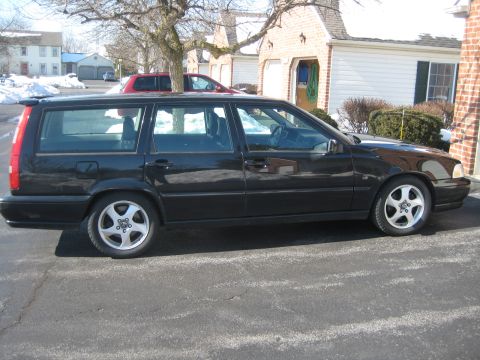 1993 Ford Probe - This black Volvo wagon is parked in front of a residential garage on a cloudy day.