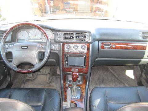 1993 Ford Probe - The dashboard and center console of a Volvo feature wood grain accents and a modern infotainment system.