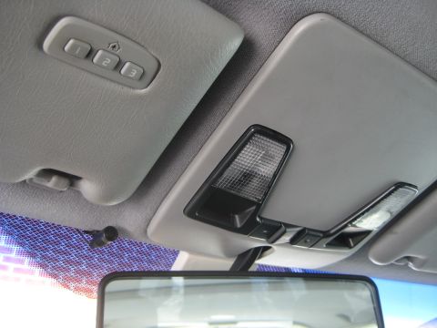 1993 Ford Probe - The overhead console features three buttons for garage door openers and two interior lights.