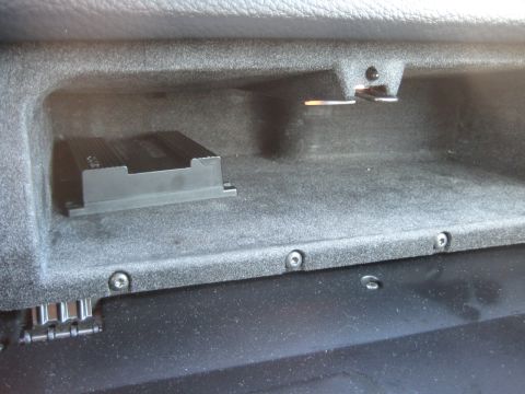 1993 Ford Probe - Interior view of a car's glove box, showing a black amplifier unit mounted inside.