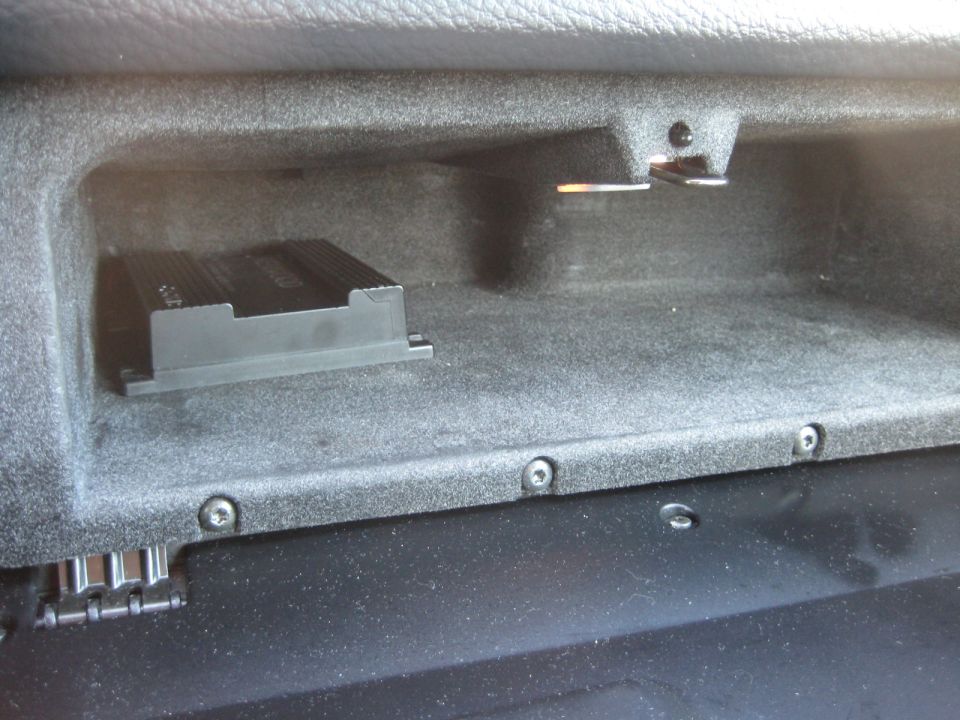 Glove box interior with black amplifier unit