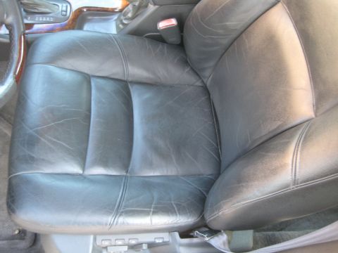 1993 Ford Probe - The interior of a vehicle shows a driver's seat with visible wear on the leather upholstery.