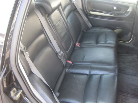 1993 Ford Probe - Interior view of black leather rear seats and seatbelts.