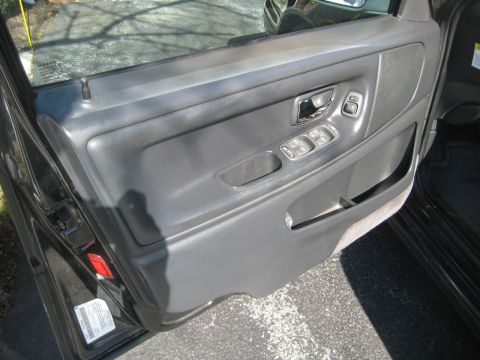 1993 Ford Probe - Close-up of a car's interior door panel, showing the power window controls and speaker grille.