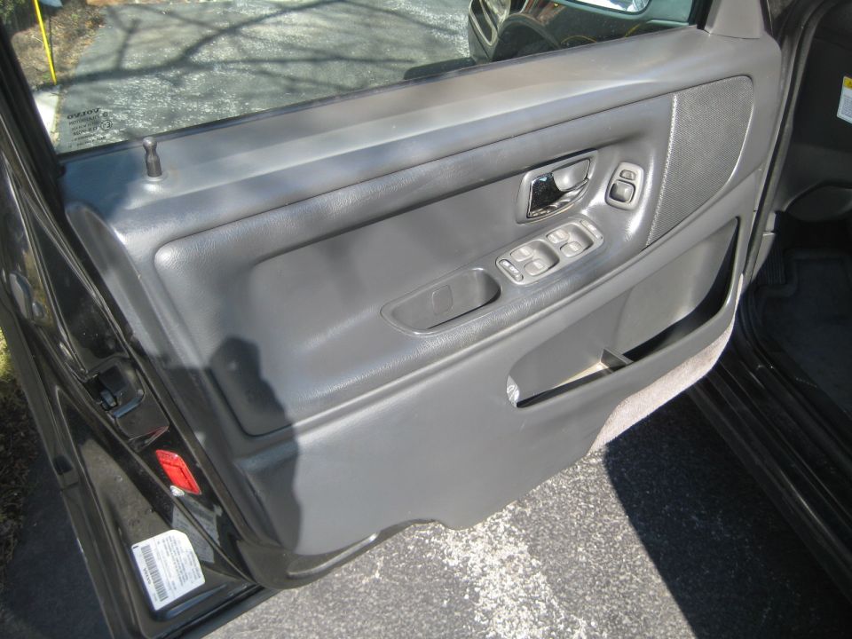Interior door panel with power window controls and speaker grille