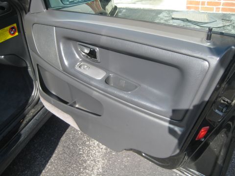 1993 Ford Probe - Close-up of a car's interior door panel, showing the armrest and door handle.