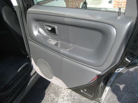 1993 Ford Probe - Close-up view of the interior door panel and controls of a vehicle.