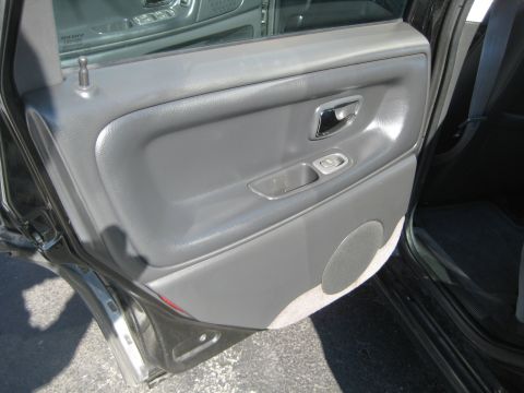 1993 Ford Probe - Close-up of a car's interior door panel, showing the armrest, door handle, and speaker grille.