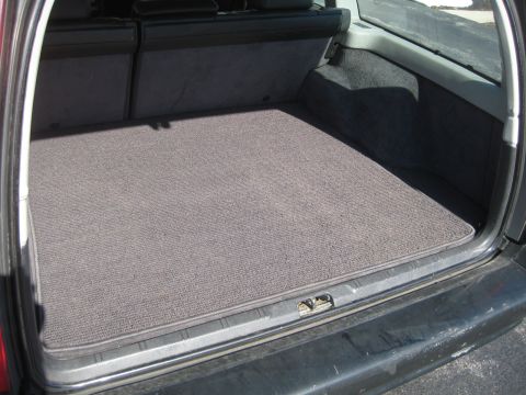 1993 Ford Probe - The cargo area of a vehicle, a carpeted floor and folded down rear seats.