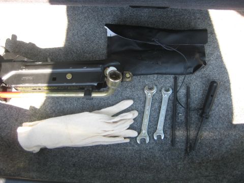 1993 Ford Probe - A set of car maintenance tools, including a jack and wrenches, are neatly organized in the vehicle's trunk.