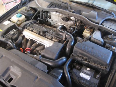 1993 Ford Probe - Engine bay view of a Volvo with a "TURBO" labeled air intake box and "VOLVO 2.0 VALVE" on the engine cover.