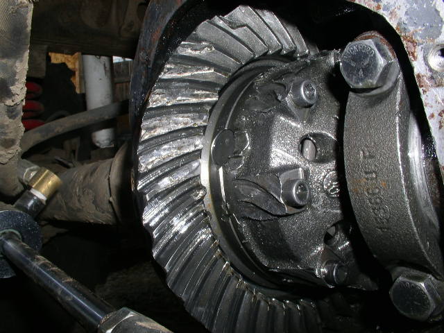 Damaged differential ring and pinion gears with visible wear and chips