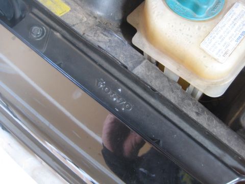 1993 Ford Probe - A close-up view of the engine bay shows the embossed Volvo logo on a black trim piece and a yellow coolant reservoir.