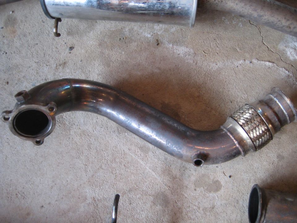Exhaust pipe with flex joint and flange, lying on concrete