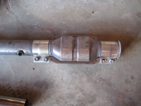 1993 Ford Probe - A close-up view of a vehicle's catalytic converter and exhaust pipe section.