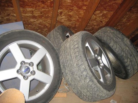 1993 Ford Probe - A set of four tires and rims are stored in an attic space.