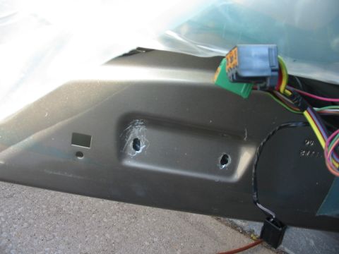 2003 Ford Crown Victoria - The interior of a car door panel is shown with electrical wiring and connectors visible.