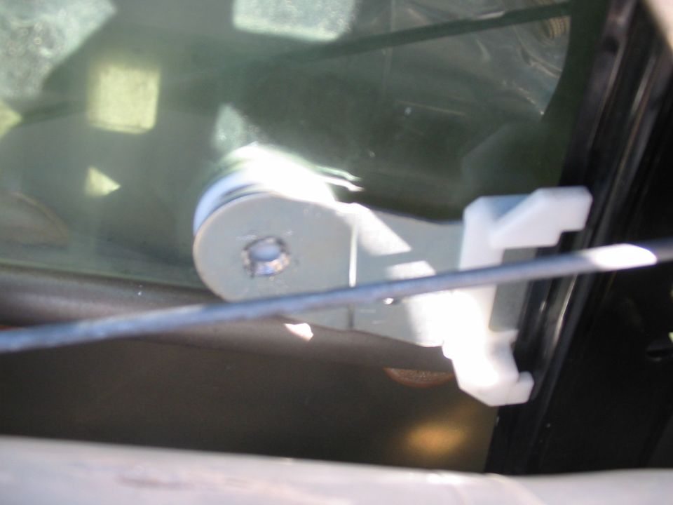 Door latch mechanism inside a car door, viewed from interior