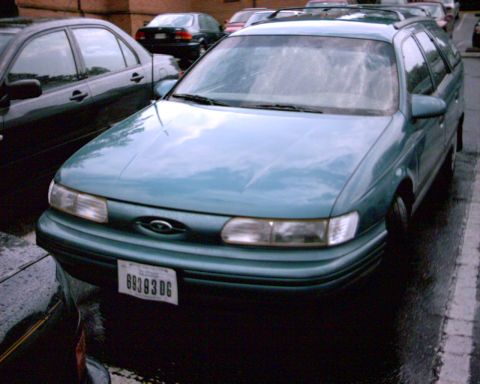 1993 Ford Taurus - This 1993 Ford Taurus station wagon is seen from the front-three-quarter angle in a parking lot.