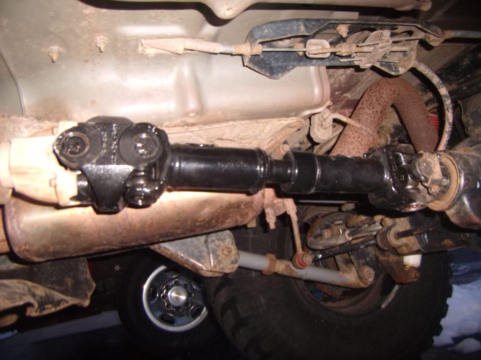 Underside view of a driveshaft and suspension components on a vehicle