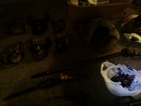 1990 Ford Bronco - Various vehicle axle parts are laid out on the ground next to a bag of hardware.