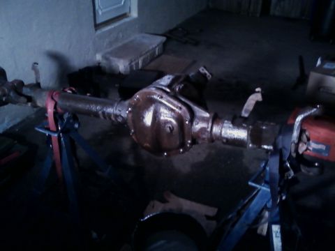 1990 Ford Bronco - Rear axle assembly, likely from a Ford truck or SUV, supported by jack stands.
