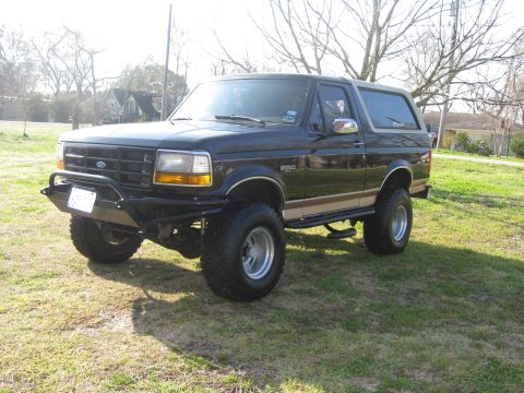 1994 Ford Bronco - This lifted 1994 Ford Bronco features an aftermarket front bumper and is parked outdoors.
