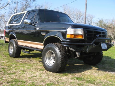 1994 Ford Bronco - This 1994 Ford Bronco features a two-tone paint scheme with tan trim and an aggressive aftermarket front bumper.