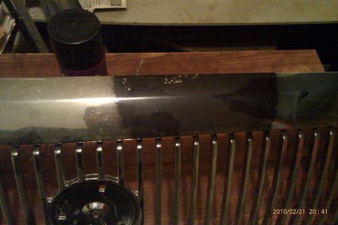 2000 Mercury Grand Marquis - A close-up view of a car's grille and chrome trim, showing some wear and tear.