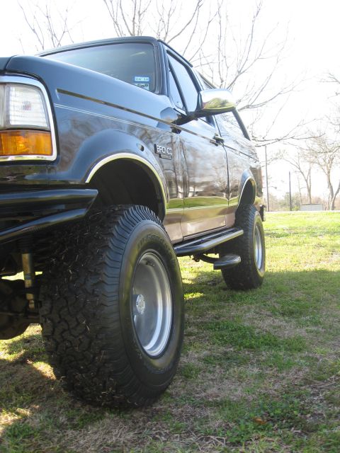 1994 Ford Bronco - This lifted Ford Bronco has large off-road tires and a chrome side step.
