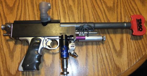 1978 Chevrolet C/K Pickup - This paintball marker features a black grip and a distinctive red TASO handle on the rear.