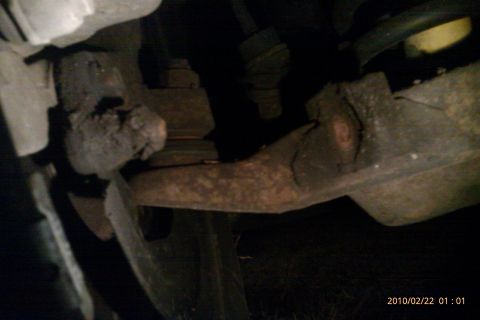 2000 Mercury Grand Marquis - This image shows a close-up view of heavily corroded vehicle suspension components.